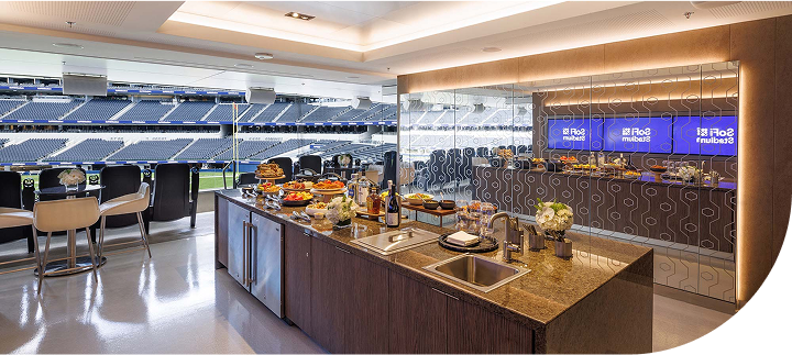 Spacious kitchen island in a private suite overlooking a sports stadium