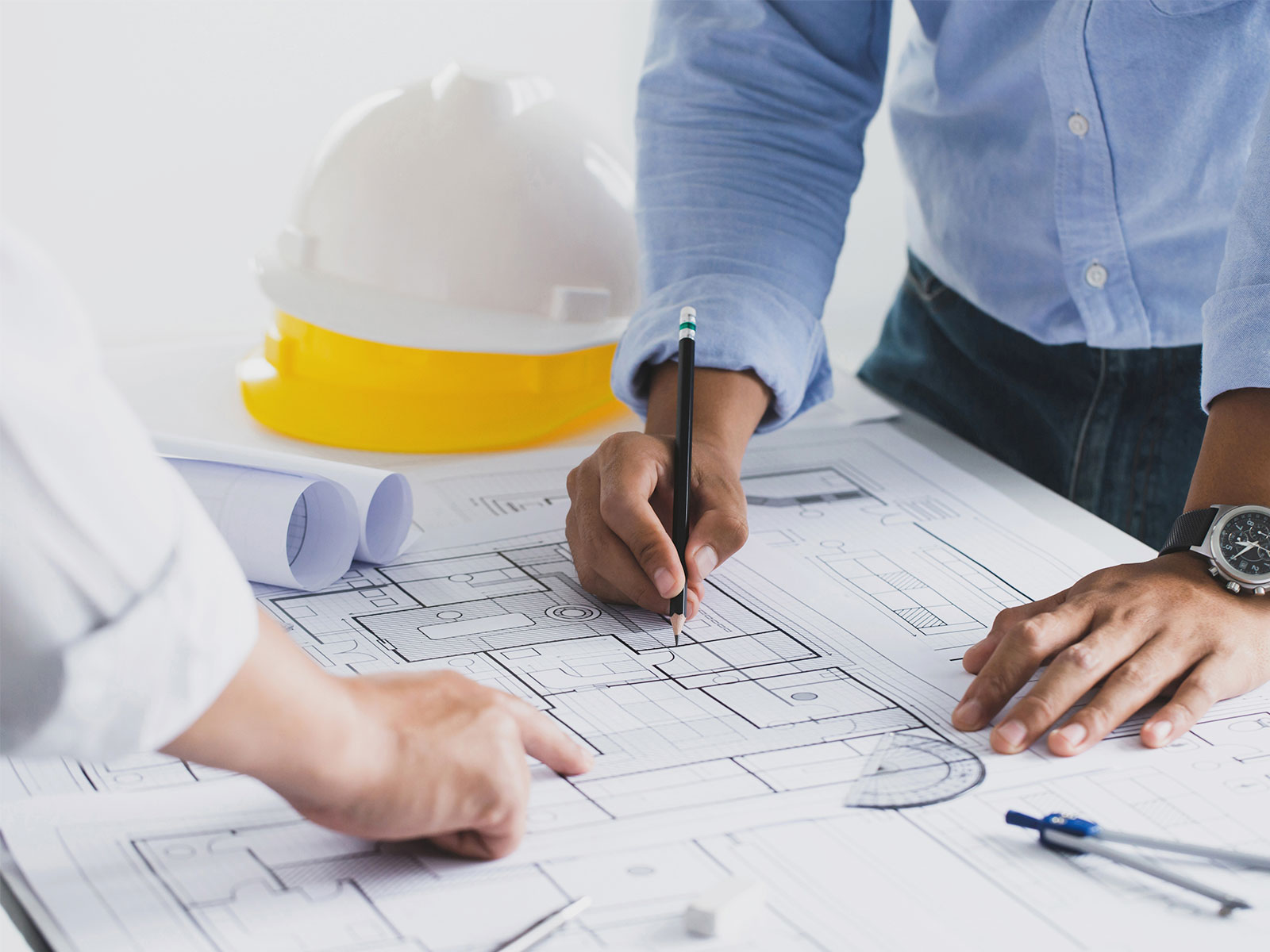Project Management and designers work on blueprints together.
