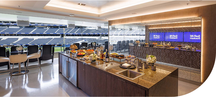 Spacious kitchen island in a private suite overlooking a sports stadium