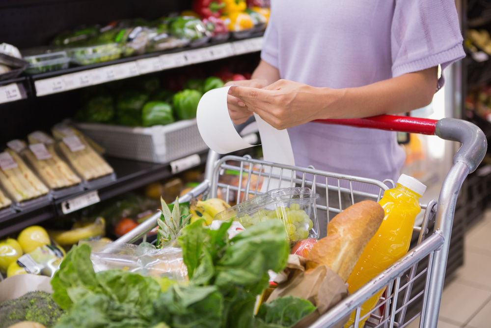 Woman reading her shopping list in aisle